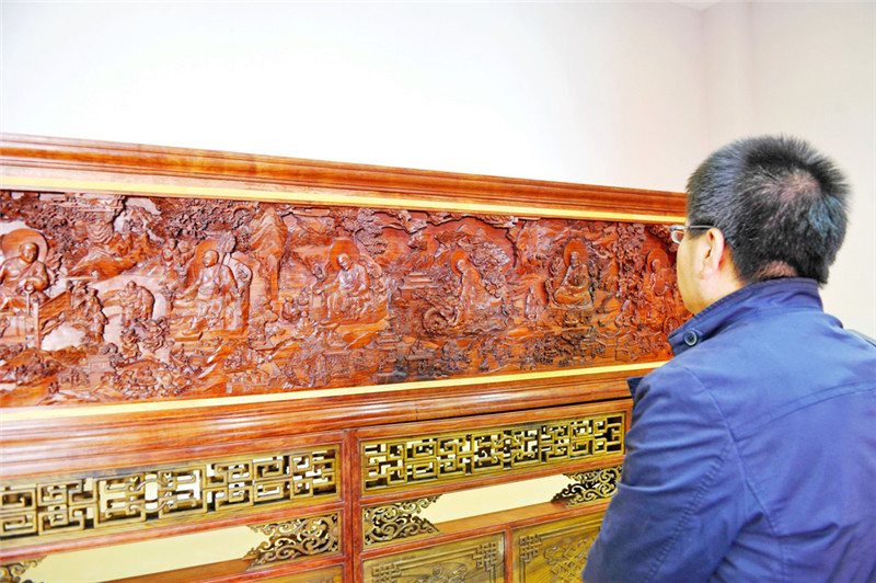 一名参观者在拍摄童永全的木雕唐卡作品(8月29日摄)。新华社记者 张汝锋 摄