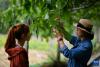 刘利平博士（右一）在加查县安绕镇热果村一株古核桃树下给学生开展现场教学（7月27日摄）。新华社记者 姜帆 摄